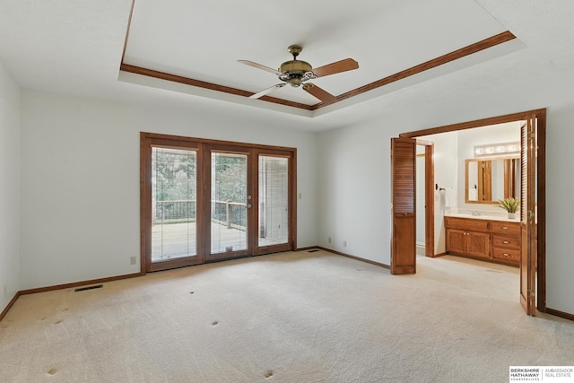 15618 L St, Omaha, NE 68135 - empty room featuring a tray ceiling, ceiling fan, and light colored carpet