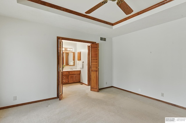 15618 L St, Omaha, NE 68135 - unfurnished bedroom featuring a tray ceiling, light carpet, ensuite bathroom, and ceiling fan