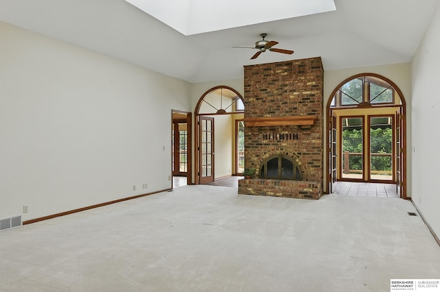 15618 L St, Omaha, NE 68135 - unfurnished living room featuring a skylight, ceiling fan, carpet, high vaulted ceiling, and a brick fireplace