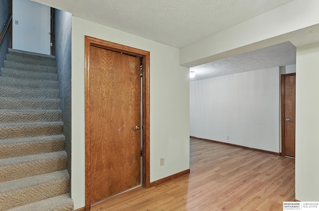 15618 L St, Omaha, NE 68135 - staircase with wood finished floors and a textured ceiling