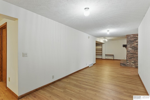 15618 L St, Omaha, NE 68135 - unfurnished room featuring light wood finished floors and a textured ceiling
