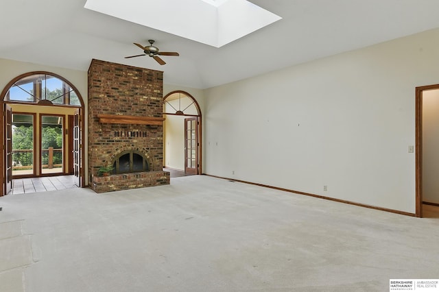 15618 L St, Omaha, NE 68135 - unfurnished living room with a skylight, carpet flooring, vaulted ceiling, ceiling fan, and a brick fireplace