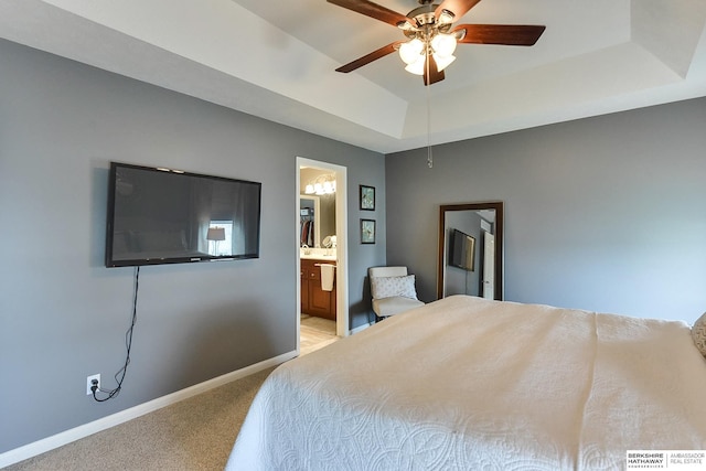 16501 Aurora St, Omaha, NE 68136 - bedroom with light carpet, a tray ceiling, connected bathroom, and a ceiling fan