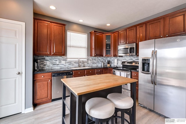 16501 Aurora St, Omaha, NE 68136 - kitchen with stainless steel appliances, light wood finished floors, decorative backsplash, wood counters, and recessed lighting