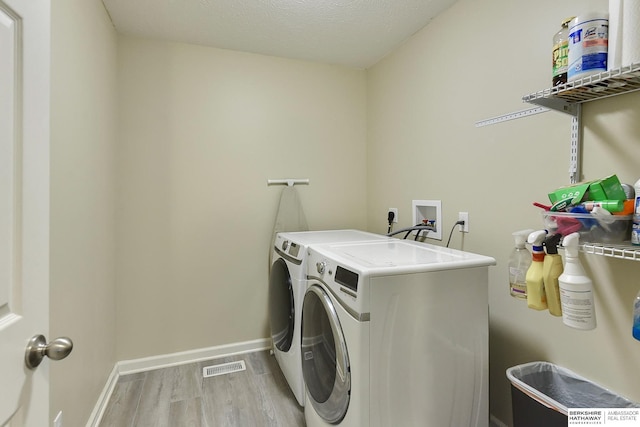 16501 Aurora St, Omaha, NE 68136 - washroom with separate washer and dryer and light wood-style flooring