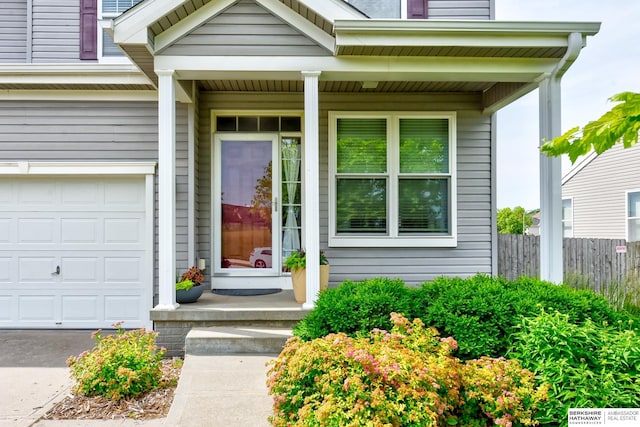 16501 Aurora St, Omaha, NE 68136 - entrance to property featuring a porch, an attached garage, and driveway
