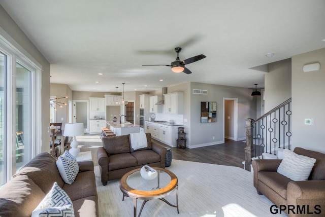 3103 N 184th St, Elkhorn, NE 68022 - living room with a ceiling fan, plenty of natural light, dark wood-style flooring, stairs, and recessed lighting