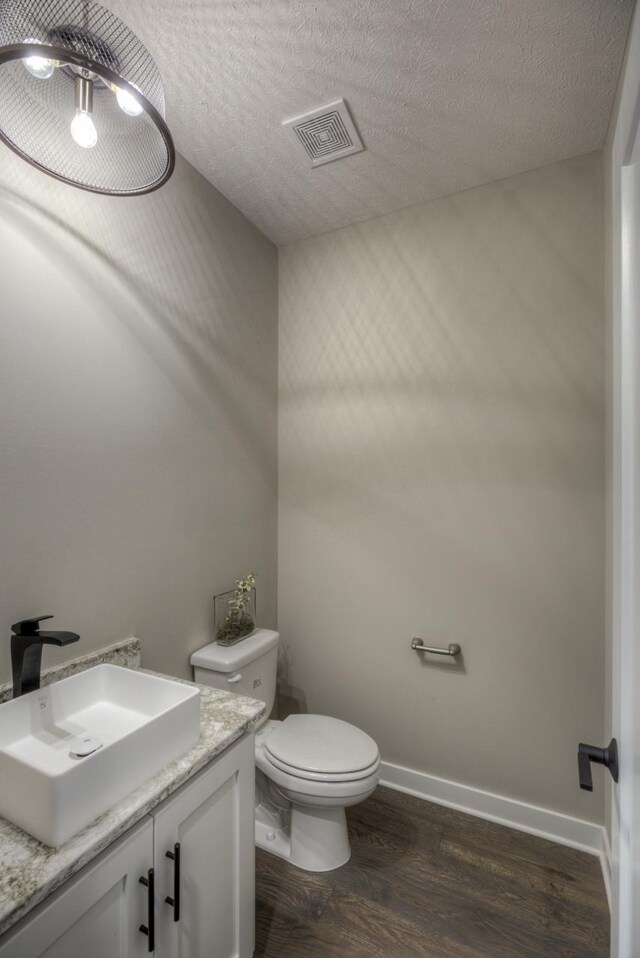 3103 N 184th St, Elkhorn, NE 68022 - half bathroom featuring vanity, wood finished floors, and a textured ceiling