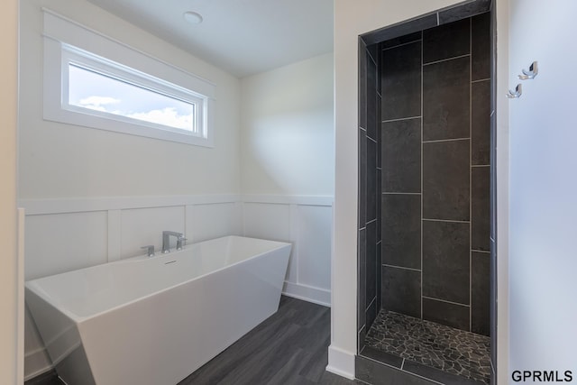 3103 N 184th St, Elkhorn, NE 68022 - full bath with a soaking tub, wood finished floors, a wainscoted wall, a tile shower, and a decorative wall