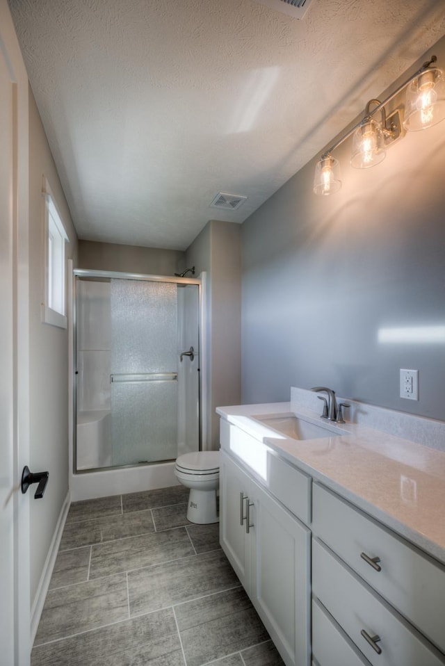 3103 N 184th St, Elkhorn, NE 68022 - bathroom featuring vanity, a shower stall, and a textured ceiling