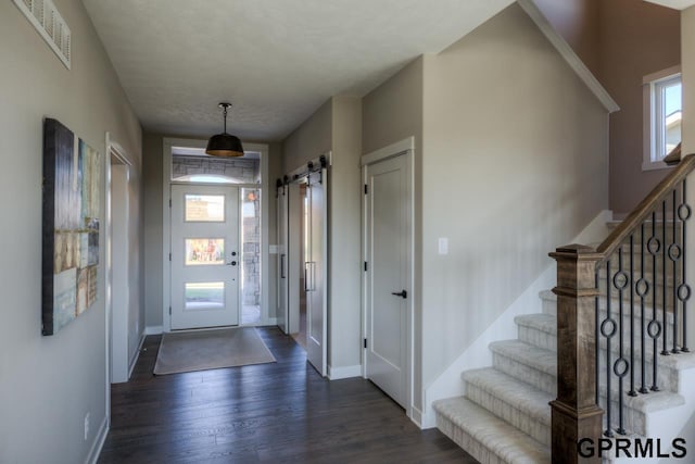 3103 N 184th St, Elkhorn, NE 68022 - foyer entrance featuring a barn door, dark wood-style floors, and stairway