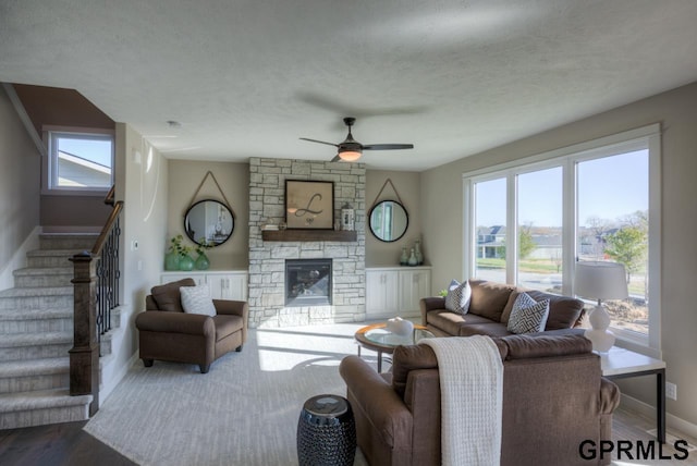 3103 N 184th St, Elkhorn, NE 68022 - living area featuring a ceiling fan, stairway, healthy amount of natural light, a fireplace, and a textured ceiling