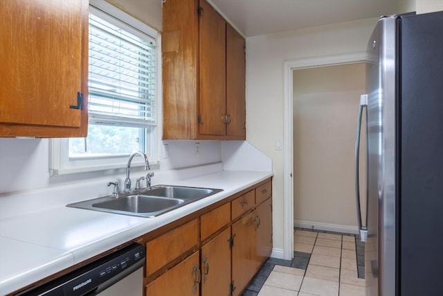 1805 Collins Dr, Bellevue, NE 68005 - kitchen with appliances with stainless steel finishes, light countertops, light tile patterned floors, and brown cabinets