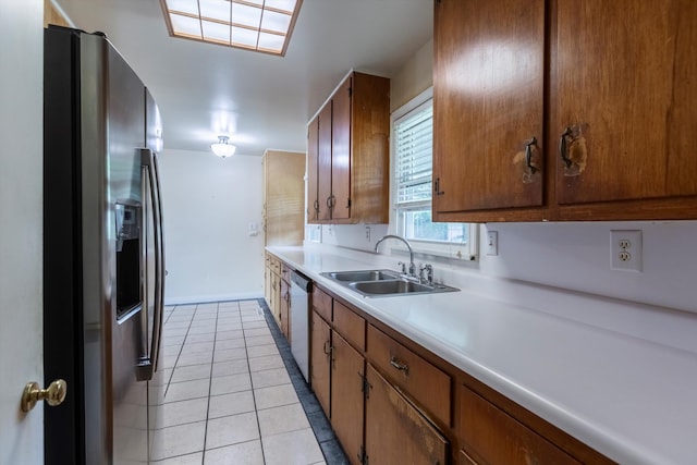 1805 Collins Dr, Bellevue, NE 68005 - kitchen featuring stainless steel fridge with ice dispenser, white dishwasher, light countertops, light tile patterned flooring, and brown cabinetry