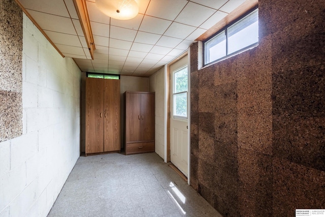 1805 Collins Dr, Bellevue, NE 68005 - hall featuring plenty of natural light, concrete block wall, and light floors
