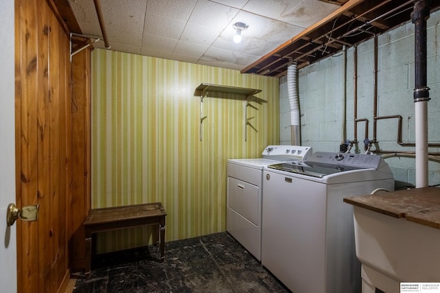 1805 Collins Dr, Bellevue, NE 68005 - laundry room with washing machine and dryer, concrete block wall, and wallpapered walls