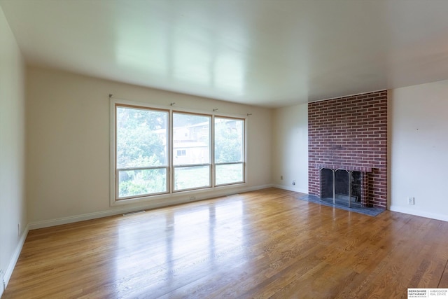1805 Collins Dr, Bellevue, NE 68005 - unfurnished living room with a brick fireplace and wood finished floors