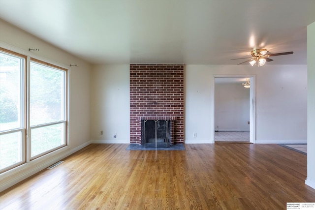 1805 Collins Dr, Bellevue, NE 68005 - unfurnished living room featuring wood finished floors, a fireplace, and ceiling fan