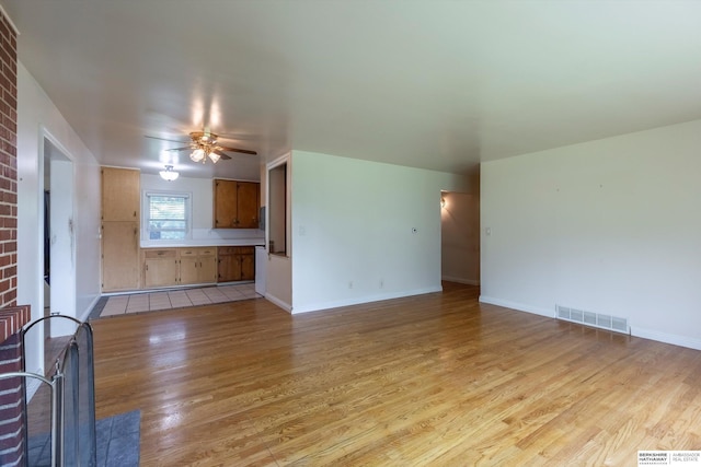 1805 Collins Dr, Bellevue, NE 68005 - unfurnished living room featuring light wood-style floors and ceiling fan