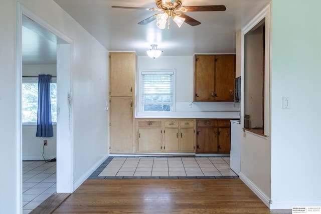 1805 Collins Dr, Bellevue, NE 68005 - kitchen featuring ceiling fan, light tile patterned floors, and light countertops