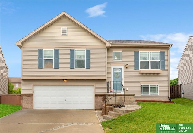 8867 Kimball St, Omaha, NE 68122 - raised ranch featuring a garage and concrete driveway