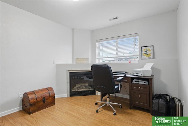 8867 Kimball St, Omaha, NE 68122 - office with a glass covered fireplace and light wood-type flooring