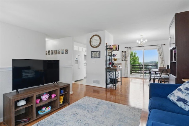 8867 Kimball St, Omaha, NE 68122 - living room featuring a chandelier and wood finished floors