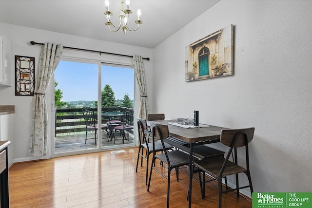 8867 Kimball St, Omaha, NE 68122 - dining area featuring wood finished floors and a chandelier