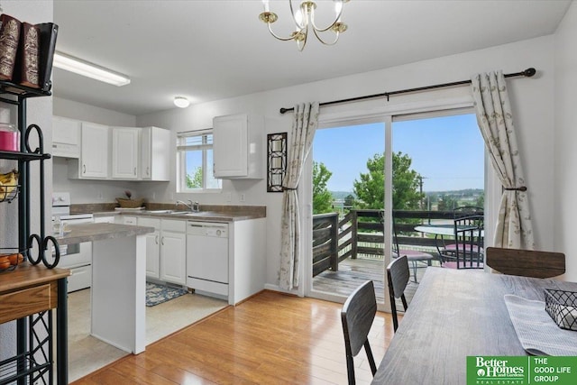 8867 Kimball St, Omaha, NE 68122 - kitchen featuring white appliances, range hood, white cabinetry, a chandelier, and light wood-type flooring