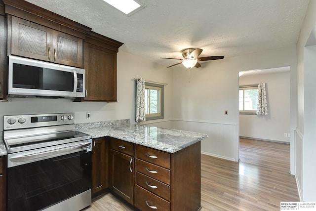 1324 S 162nd St, Omaha, NE 68130 - kitchen featuring appliances with stainless steel finishes, a ceiling fan, dark brown cabinets, a peninsula, and light wood-type flooring