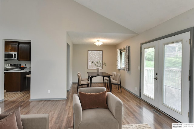 1324 S 162nd St, Omaha, NE 68130 - living area featuring french doors, light wood finished floors, and high vaulted ceiling
