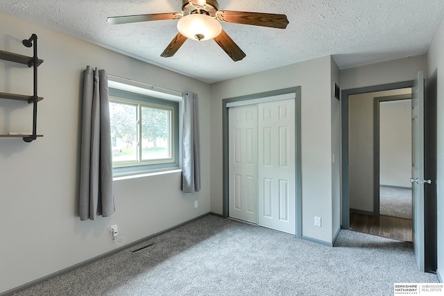 1324 S 162nd St, Omaha, NE 68130 - unfurnished bedroom with carpet flooring, a closet, a textured ceiling, and ceiling fan
