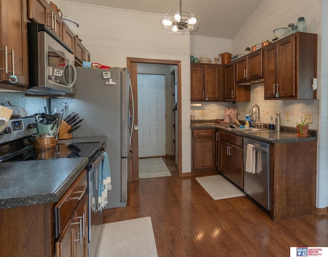 85 Vince Dr, Bennet, NE 68317 - kitchen with appliances with stainless steel finishes, dark countertops, vaulted ceiling, and dark wood-type flooring