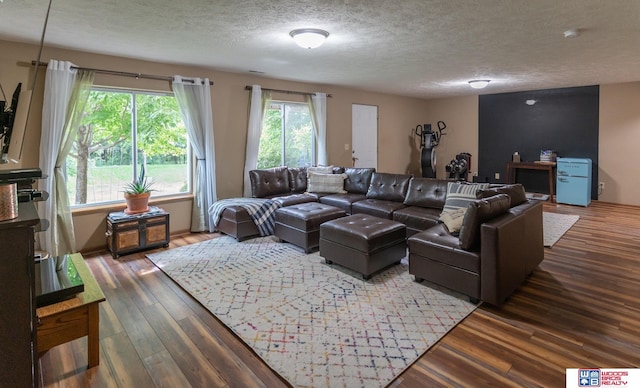 85 Vince Dr, Bennet, NE 68317 - living area featuring a textured ceiling and wood finished floors