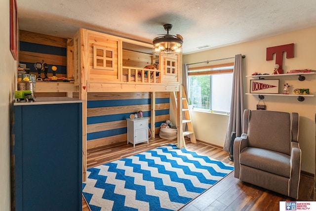 85 Vince Dr, Bennet, NE 68317 - bedroom featuring a textured ceiling and wood finished floors