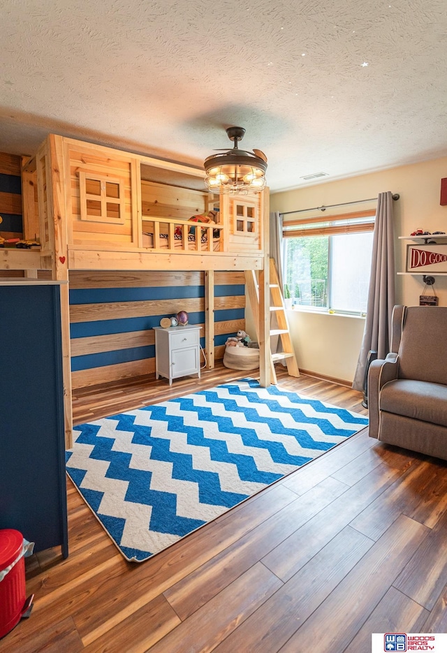 85 Vince Dr, Bennet, NE 68317 - bedroom with a textured ceiling and wood finished floors