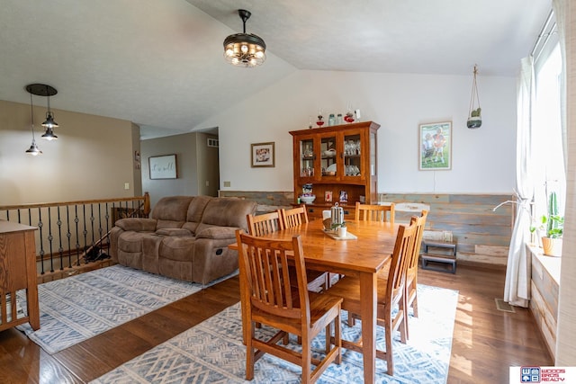 85 Vince Dr, Bennet, NE 68317 - dining room featuring lofted ceiling, wood finished floors, and a wainscoted wall