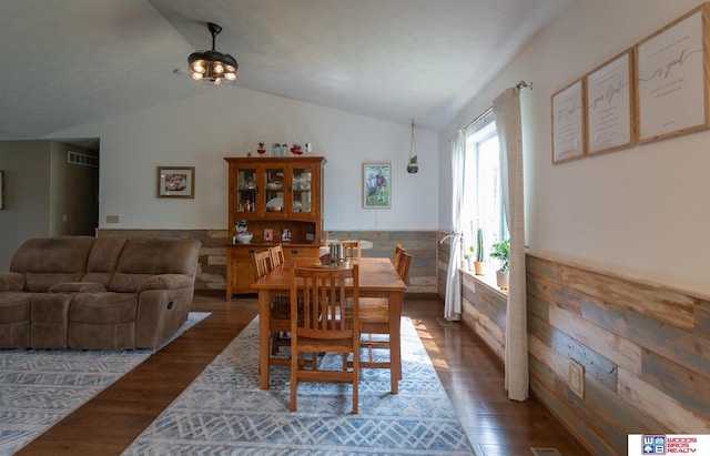 85 Vince Dr, Bennet, NE 68317 - dining room featuring vaulted ceiling, dark wood-style flooring, and a wainscoted wall