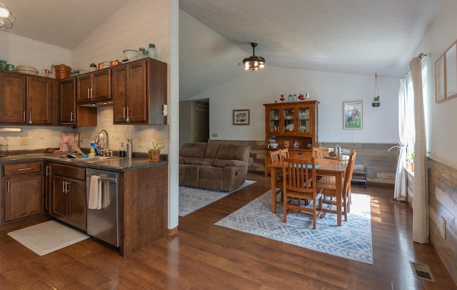 85 Vince Dr, Bennet, NE 68317 - kitchen with dishwasher, lofted ceiling, dark countertops, dark wood-style flooring, and wainscoting