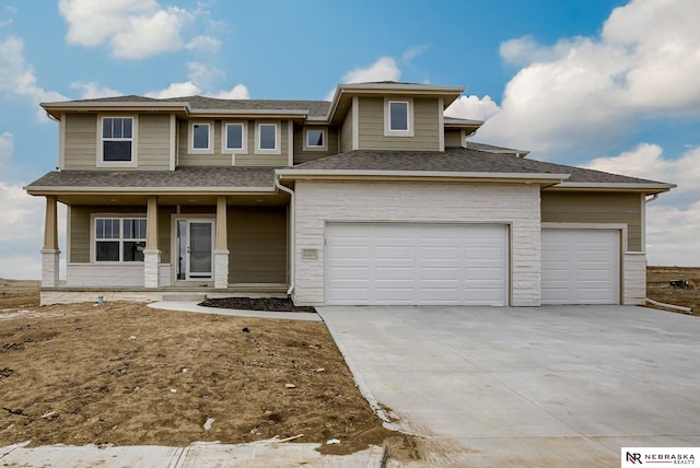 11920 S 109th St, Papillion, NE 68046 - prairie-style house with a porch, concrete driveway, an attached garage, and a shingled roof