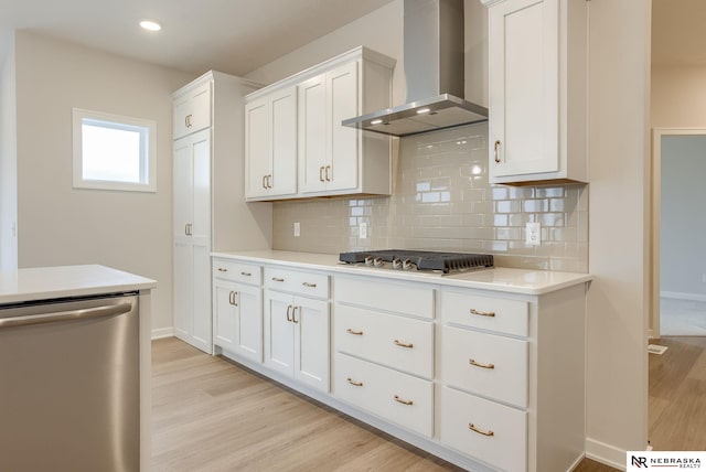 11920 S 109th St, Papillion, NE 68046 - kitchen with wall chimney exhaust hood, appliances with stainless steel finishes, light wood-style flooring, light countertops, and backsplash