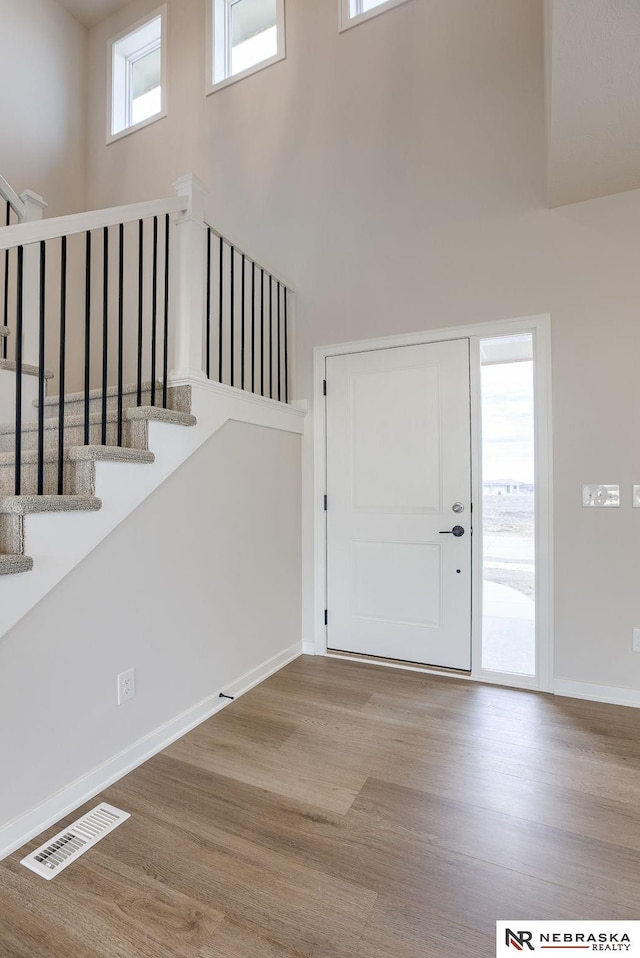 11920 S 109th St, Papillion, NE 68046 - foyer featuring wood finished floors, stairway, and a towering ceiling