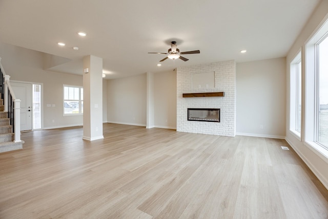 11920 S 109th St, Papillion, NE 68046 - unfurnished living room featuring stairs, ceiling fan, light wood-style flooring, a brick fireplace, and recessed lighting