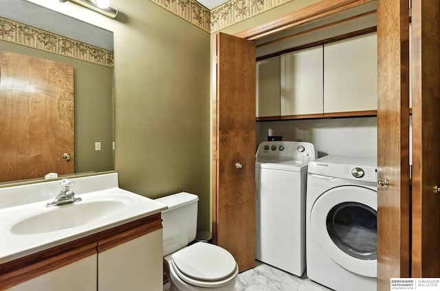 2108 S 62nd St, Omaha, NE 68106 - bathroom featuring washer and dryer, vanity, and marble look tile flooring