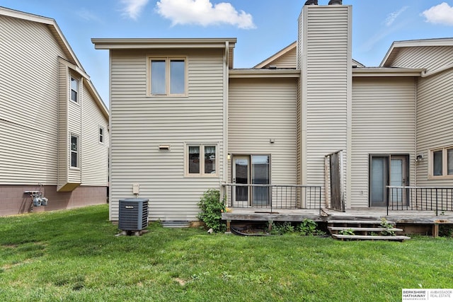 2108 S 62nd St, Omaha, NE 68106 - back of property with a deck, a lawn, and a chimney