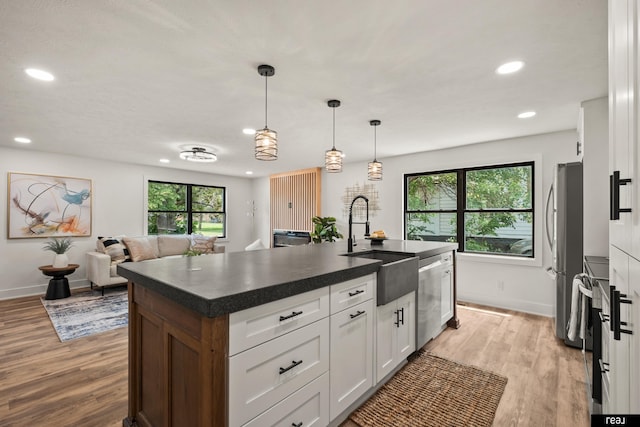 316 N 13th St, Tekamah, NE 68061 - kitchen featuring stainless steel appliances, dark countertops, recessed lighting, light wood-type flooring, and white cabinetry