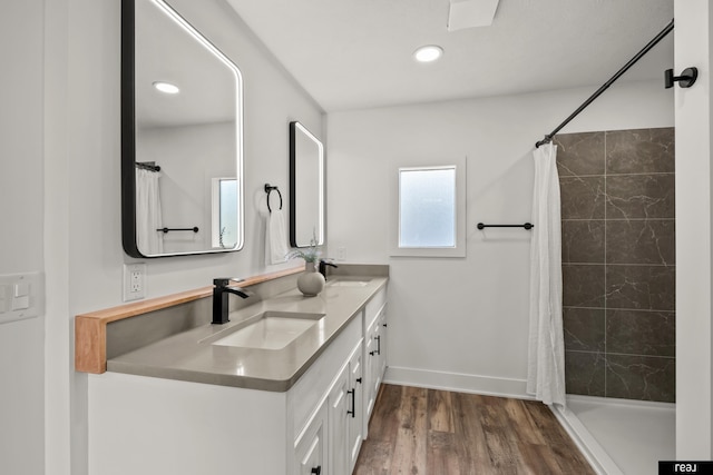 316 N 13th St, Tekamah, NE 68061 - bathroom featuring double vanity, wood finished floors, a tile shower, and recessed lighting