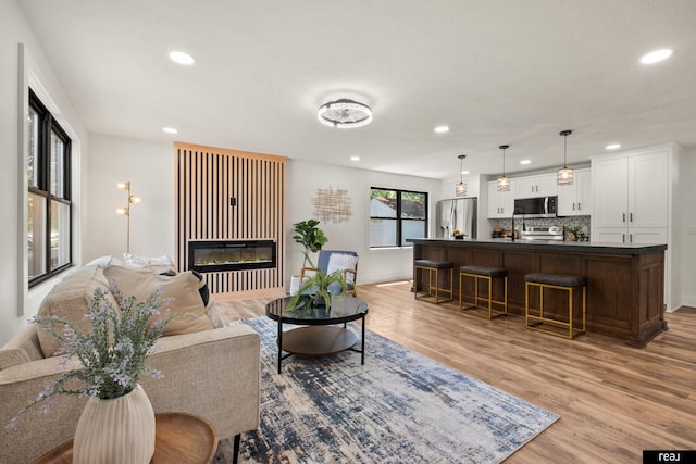 316 N 13th St, Tekamah, NE 68061 - living area with recessed lighting, a glass covered fireplace, and light wood finished floors