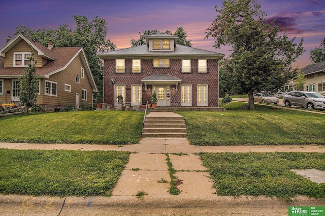 1100/1102 S 35th Ave, Omaha, NE 68105 - view of front facade featuring a yard and brick siding