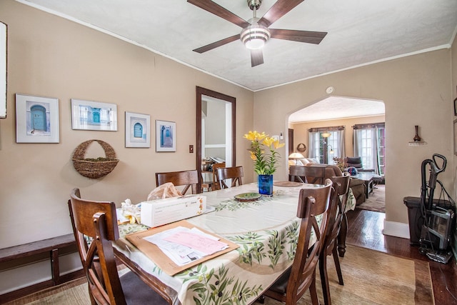 1100/1102 S 35th Ave, Omaha, NE 68105 - dining space with a ceiling fan, arched walkways, wood finished floors, and crown molding
